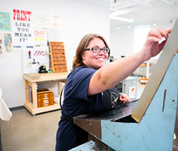 Studio art student in print lab