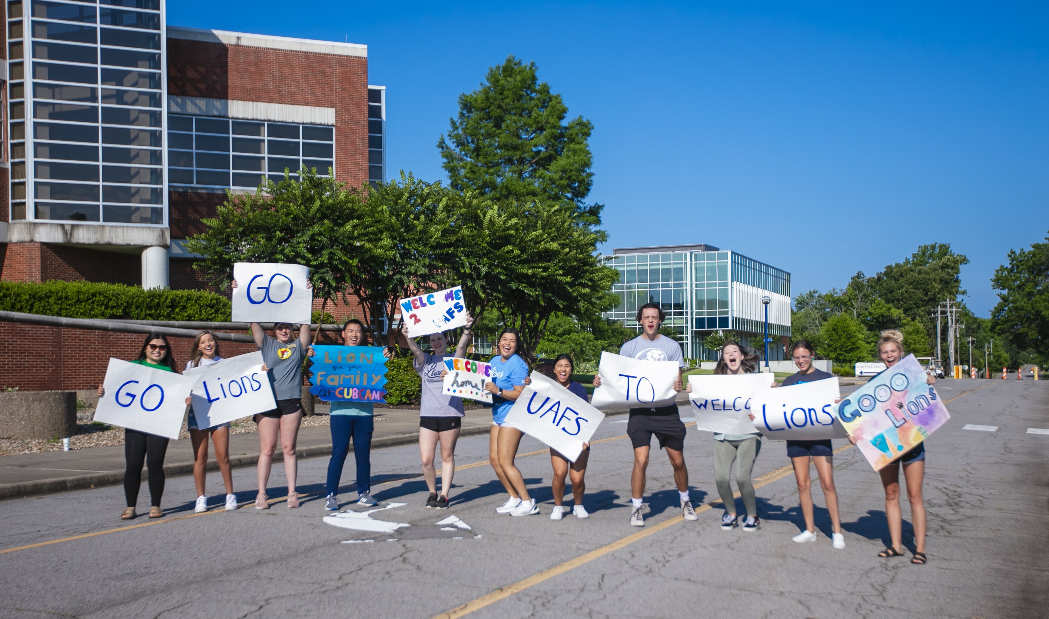 students hold signs encrouaging students