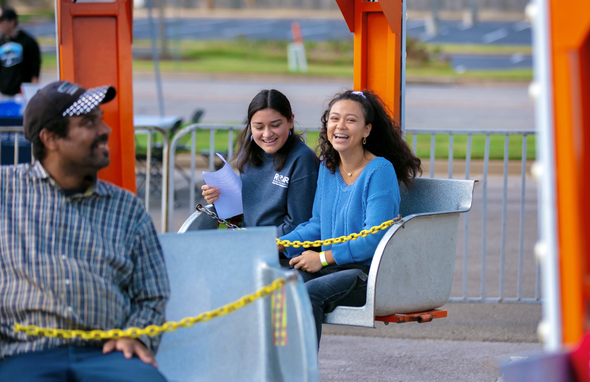 two girls on a carnival ride. 