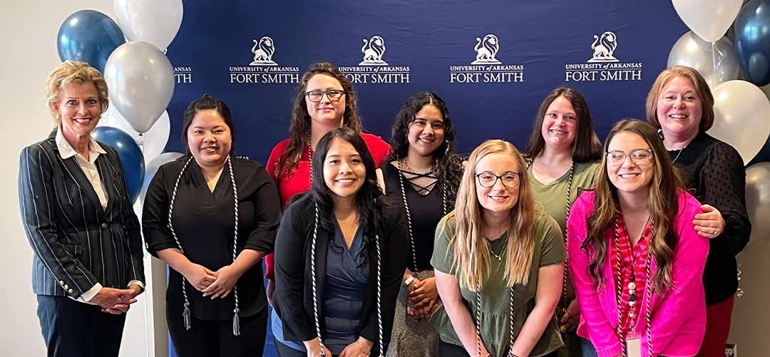 Kathy Babb, Certificate of Distinction in Professional Development graduates, and Susan Krafft pose for a photo during cord ceremony.