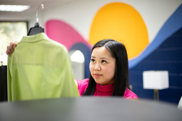 Young woman examines a jacket