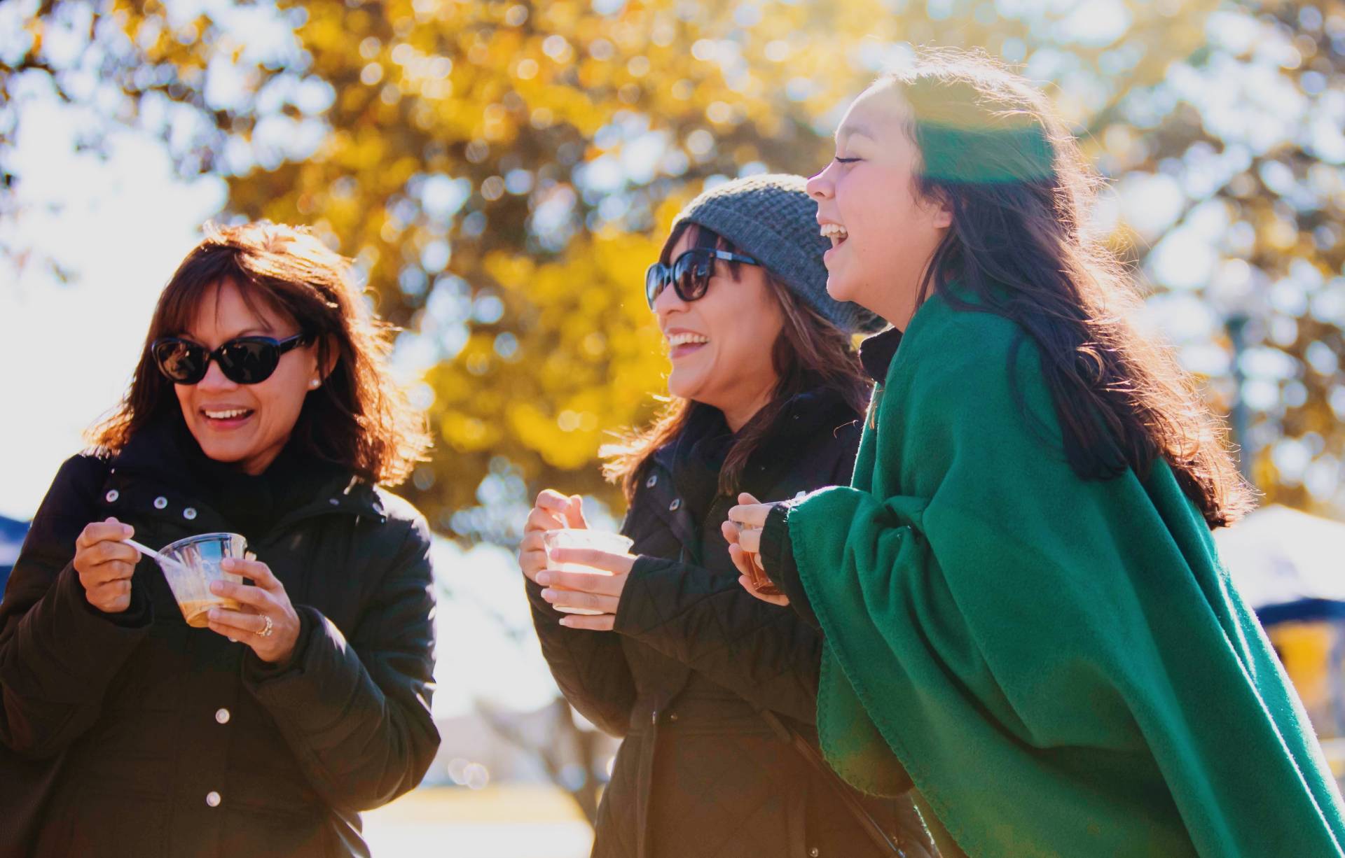 UAFS Students and family stand under fall trees