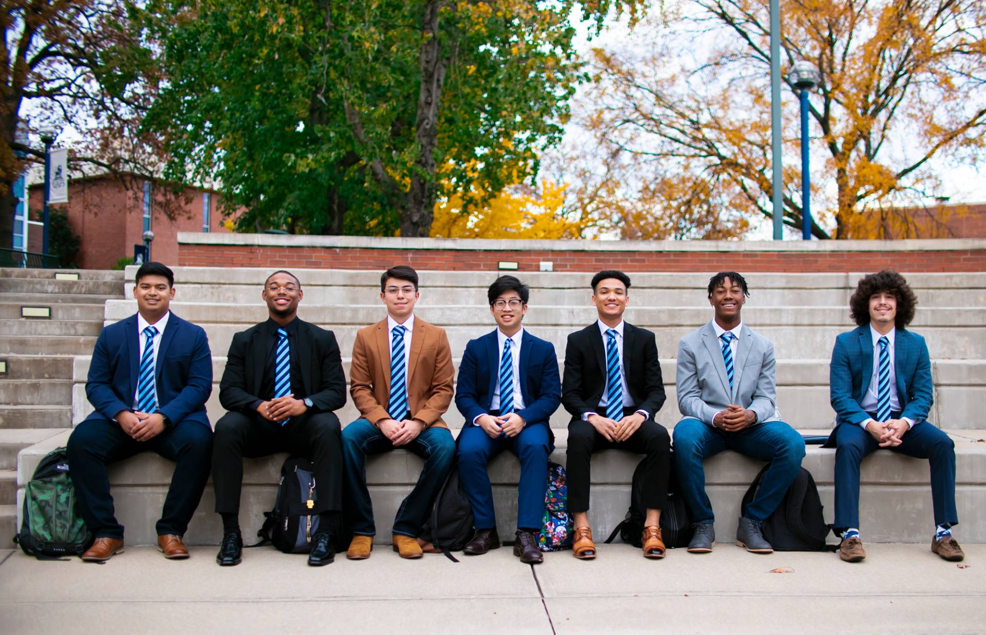 Men seated in a line in suits