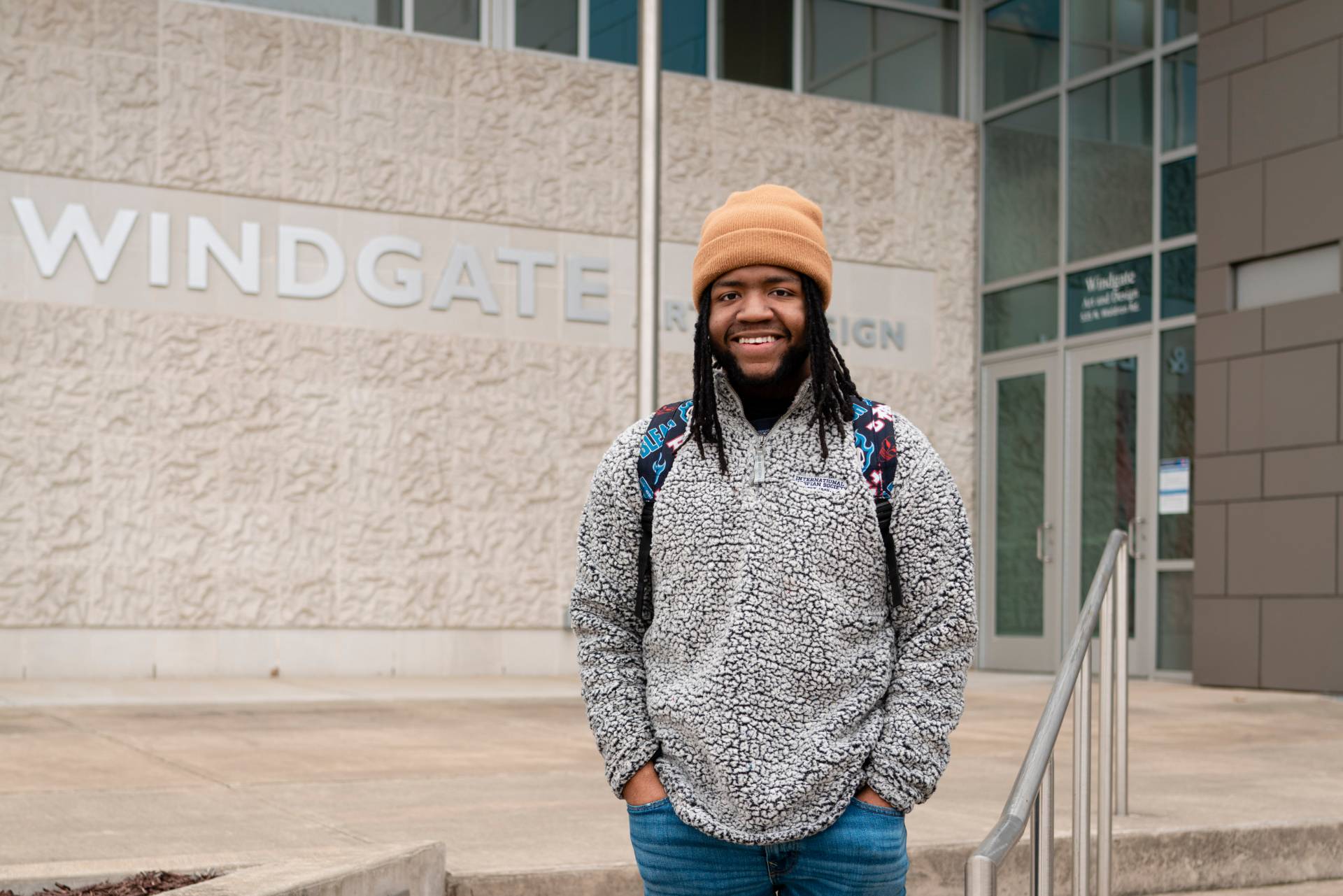 Demonte standing in front of the Windgate Building