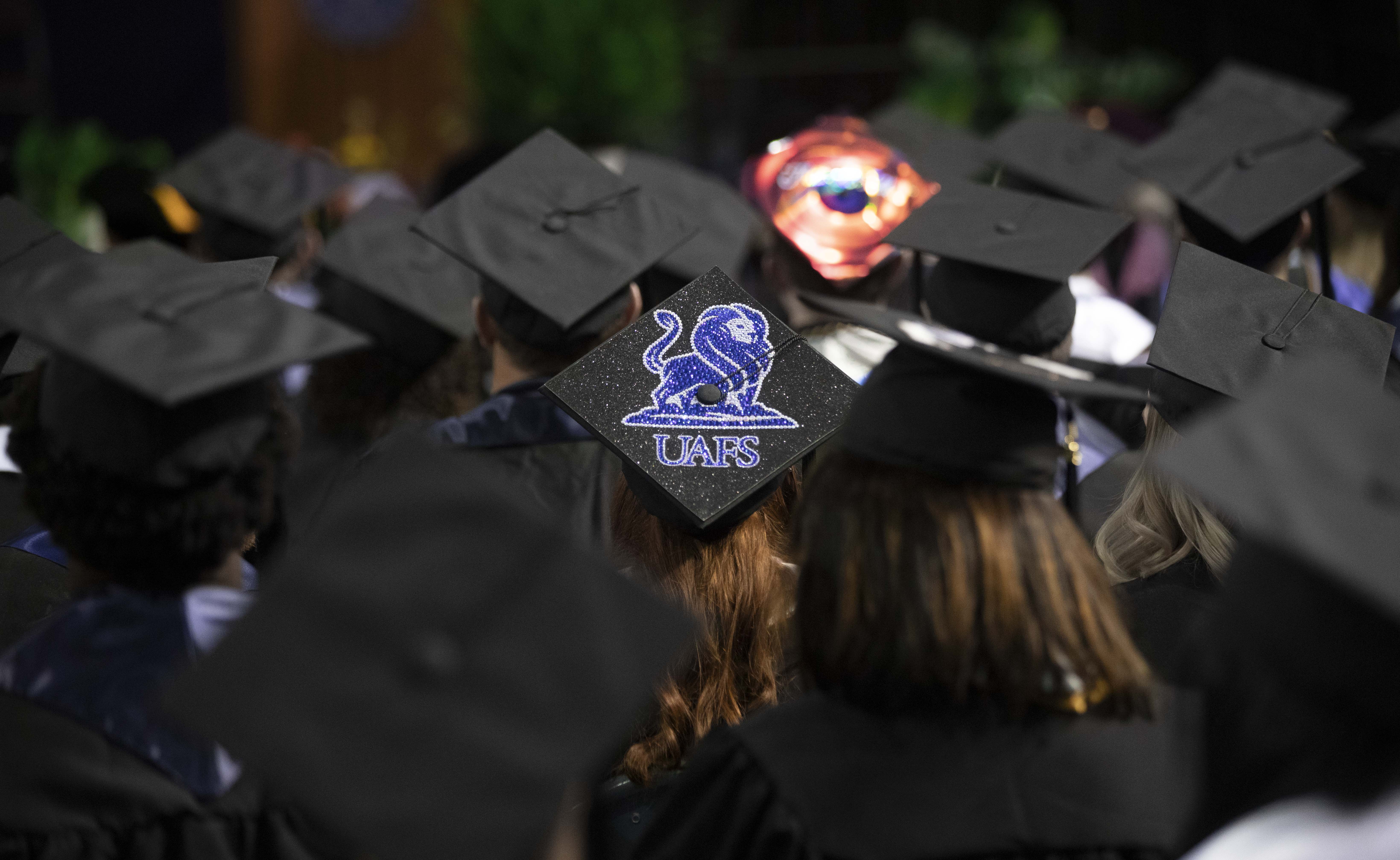 graduation caps at UAFS graduation