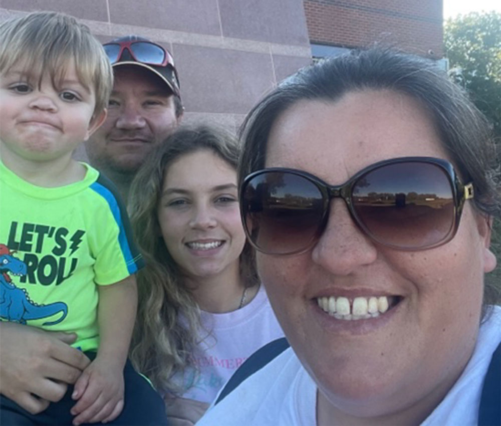 Jennifer Phelan, front-right, takes a selfie with her family