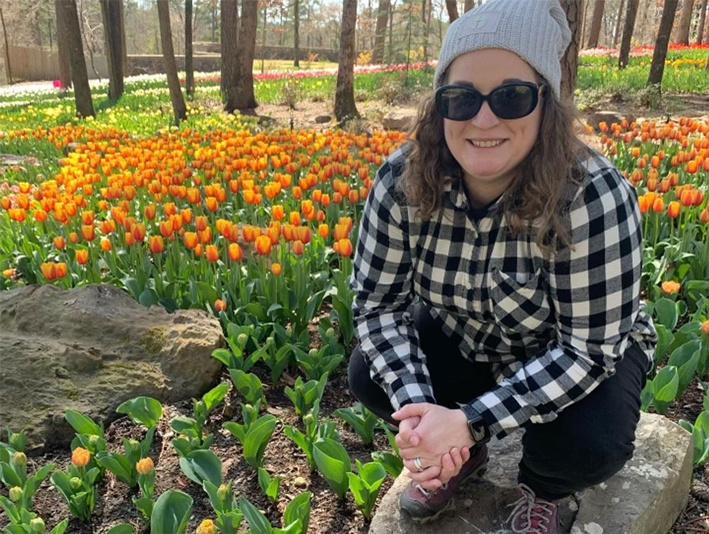 UAFS chemistry professor Jordan Mader poses in a field of tulips