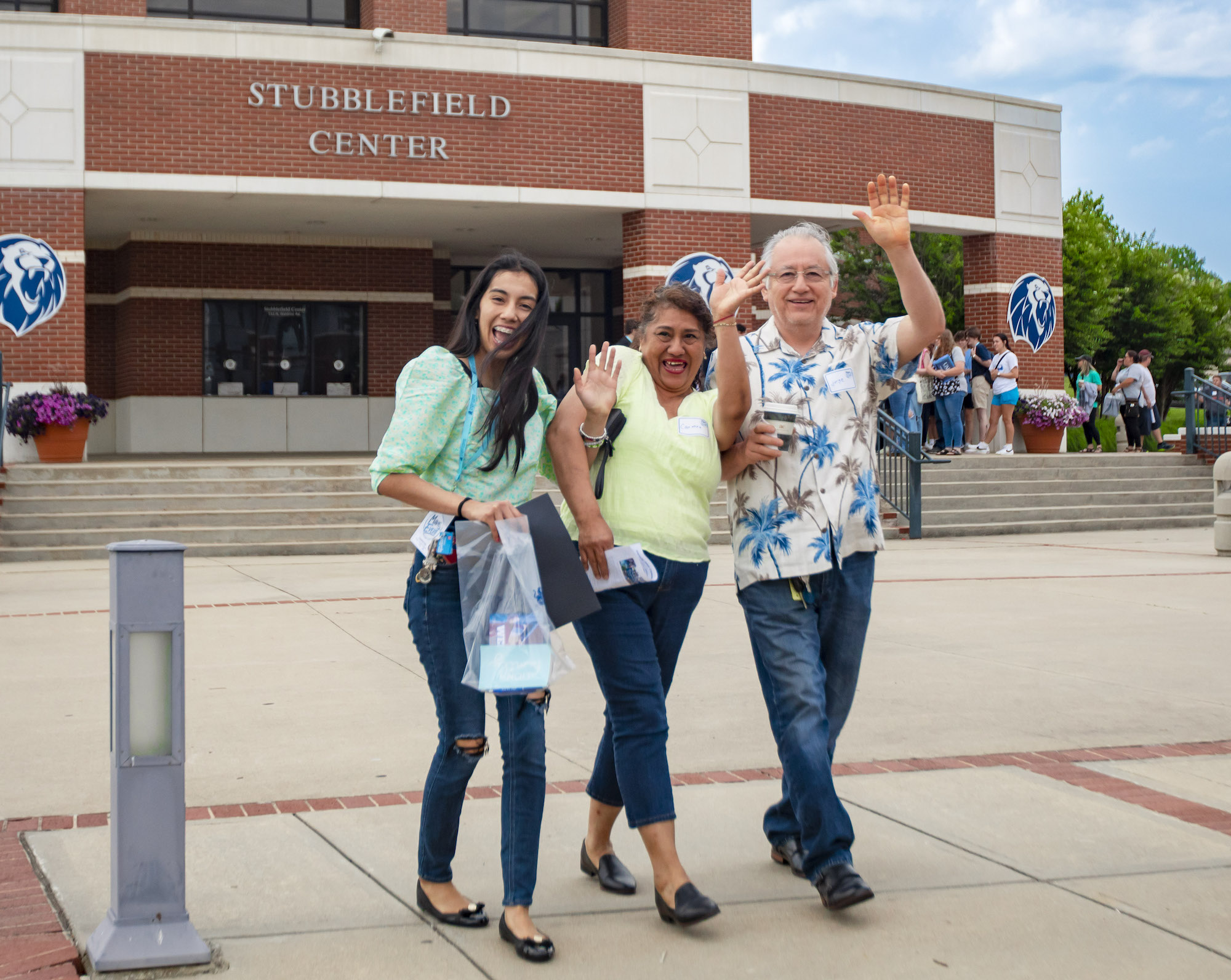 A family waves as they exit the June 2023 Mane Event 