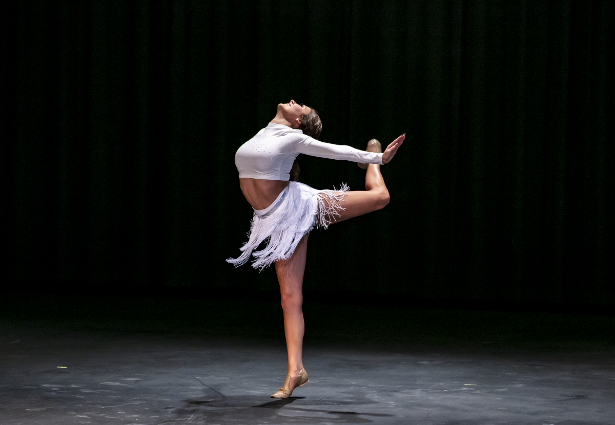 Jayson Toney dances in a white dance costume