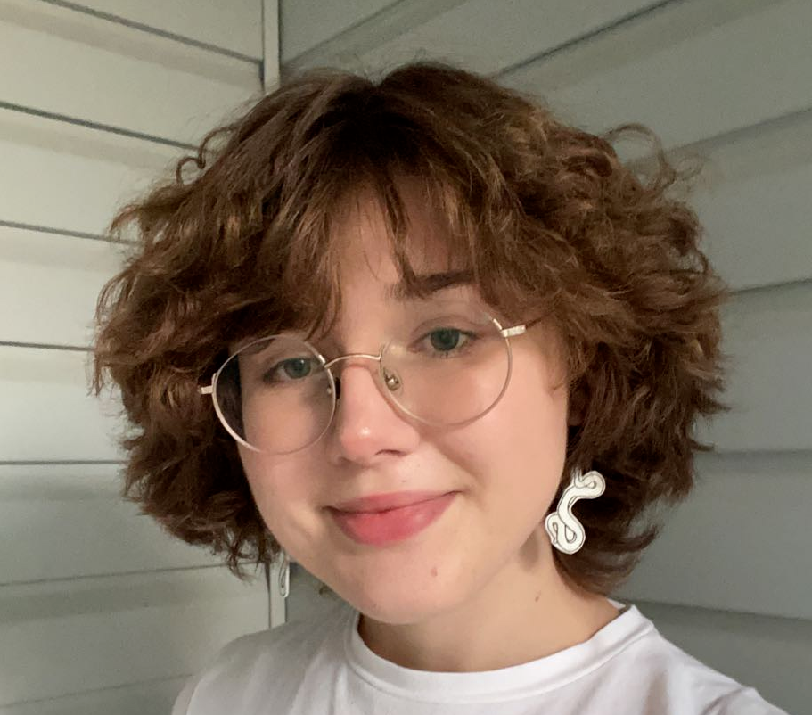 Headshot of a woman with curly hair